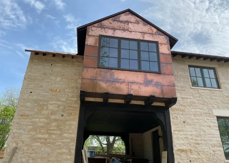 Copper metal panel facade on a stone building for Skylight Installation in Levelland