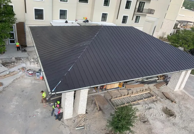 Metal roofing installation team working on a commercial building in Levelland